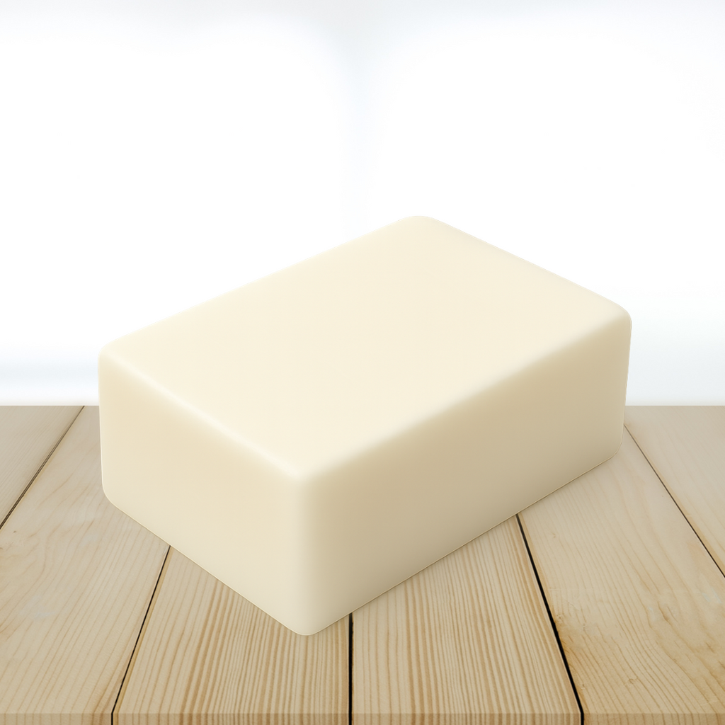 goat milk soap base block on a wooden surface with a white background