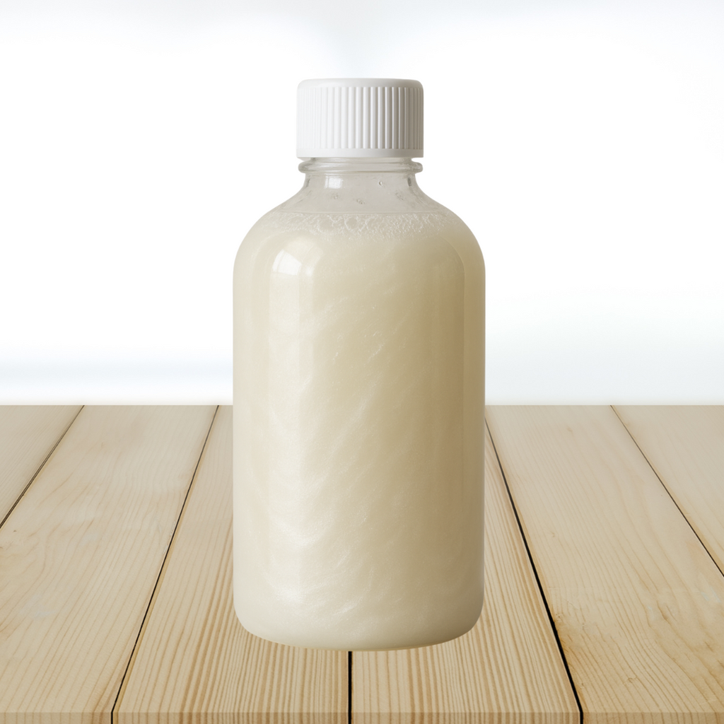 Bottle of shampoo base on a wooden surface with a white background