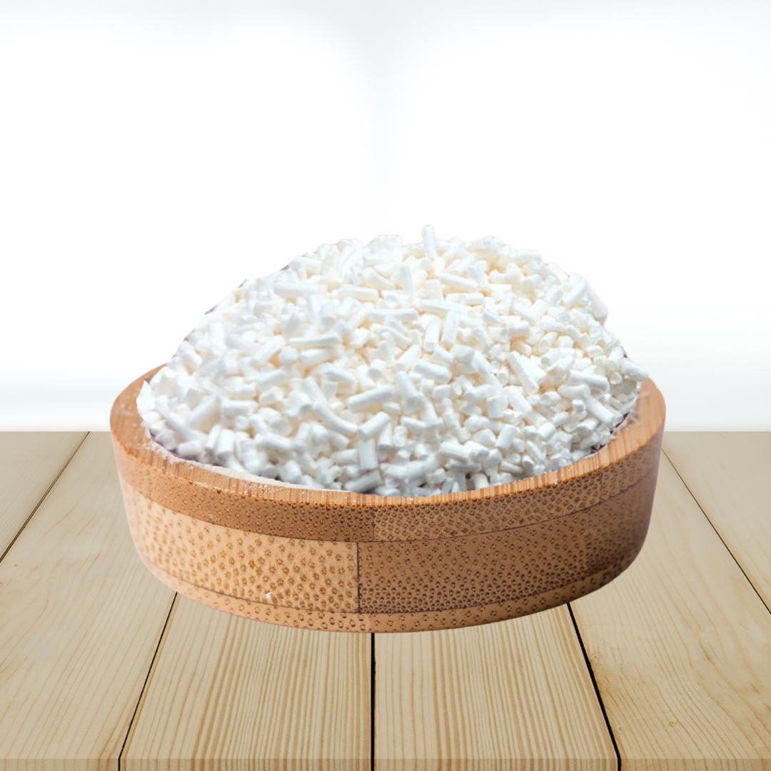 Wooden bowl filled with potassium sorbate on a wooden surface